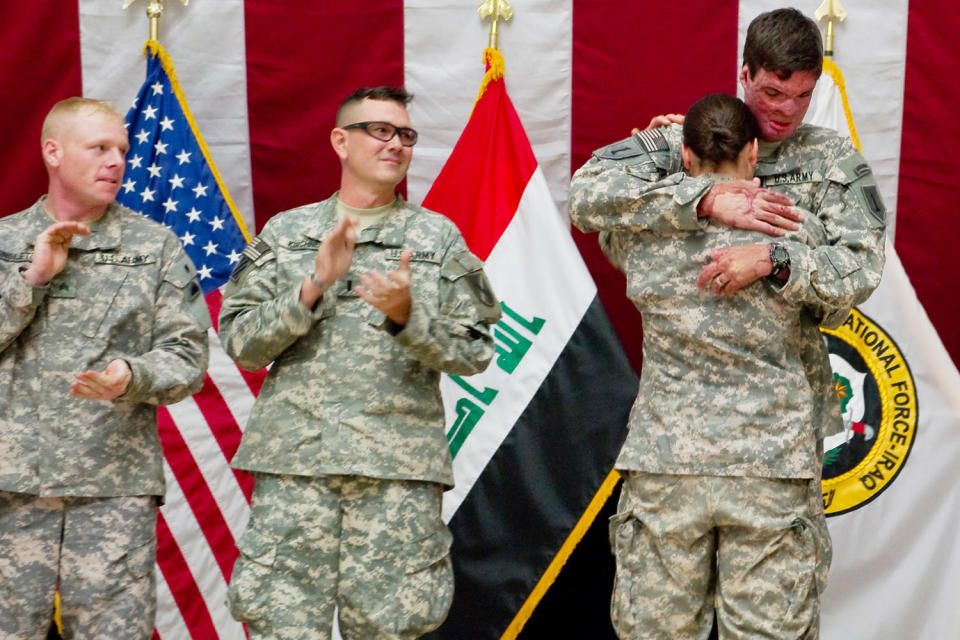 Capt. Sam Brown hugs his wife, Capt. Amy Brown, after arriving in Baghdad to take part in Operation Proper Exit. (U.S. Army)