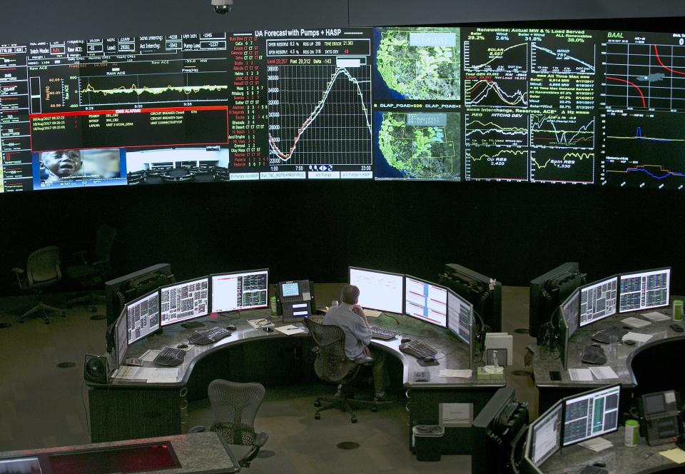 FILE - In this Aug. 18, 2017, file photo, electrical power flow, and conditions are monitored at the California Independent System Operator (California ISO) grid control center in Folsom, Calif. The managers of California's power grid are warning there could be rolling blackouts if customers don't conserve energy. Exceptionally high temperatures are driving the highest power use of the year and transmission losses due to wildfires have cut into supplies. Eric Schmitt of the California Independent System Operator said up to 3 million customers could lose power for up to four hours Sunday evening, Sept. 6, 2020. He said where those outages occur are up to local utilities. The Creek Fire in the Sequoia National Forest in central California and another fire in Southern California have knocked out transmission lines that carry about 1,600 megawatts of electricity. (AP Photo/Rich Pedroncelli, File)