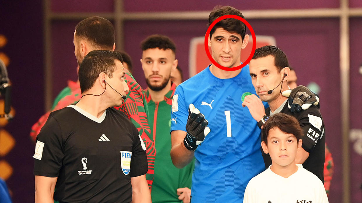 Morocco's goalkeeper Yassine Bounou speaks with referees before heading into the field at the FIFA World Cup.