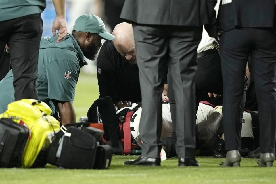 Philadelphia Eagles defensive tackle Moro Ojomo (72) is attended to after an injury during the second half of an NFL preseason football game against the Cleveland Browns on Thursday, Aug. 17, 2023, in Philadelphia. (AP Photo/Matt Rourke)