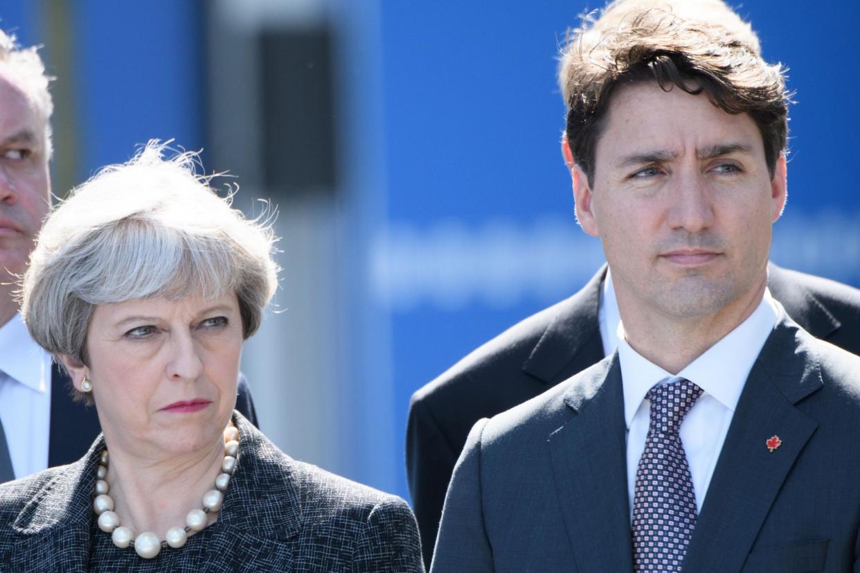 Canadian Prime Minister Justin Trudeau and Theresa May attend the unveiling ceremony of the new NATO headquarters in Brussels: Getty