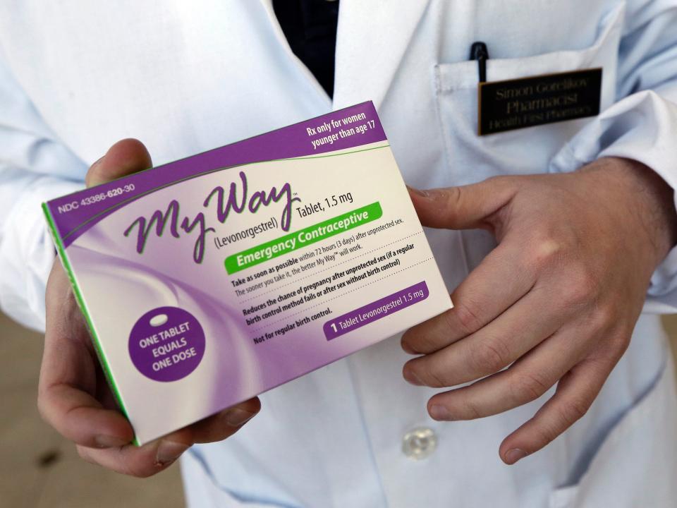 In this May 2, 2013, file photo, pharmacist Simon Gorelikov holds a generic emergency contraceptive at the Health First Pharmacy in Boston.