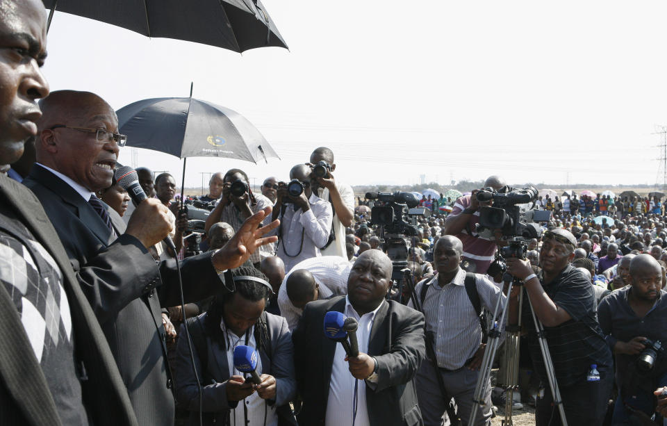 CORRECTS DATE South Africa's President Jacob Zuma, second from left, address striking mine workers at the Lonmin mine near Rustenburg, South Africa, Wednesday, Aug. 22, 2012. Demands for higher wages spread to at least two other platinum mines in South Africa and raise fears instability could spread to more of the country's mines that provide 75 percent of the world's supply of the precious metal. South Africa's miningweb.co.za Web site calls it "a possibly ominous development." A 12-day strike at the Lonmin PLC mine resulted in police killing 34 striking miners and wounding another 78 last week. (AP Photo/Themba Hadebe)