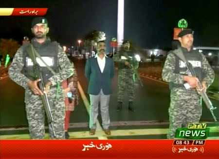 Indian pilot, Wing Commander Abhinandan, stands under armed escort near Pakistan-India border in Wagah, Pakistan in this March 1, 2019 image from a video footage. REUTERS/PTV via Reuters TV