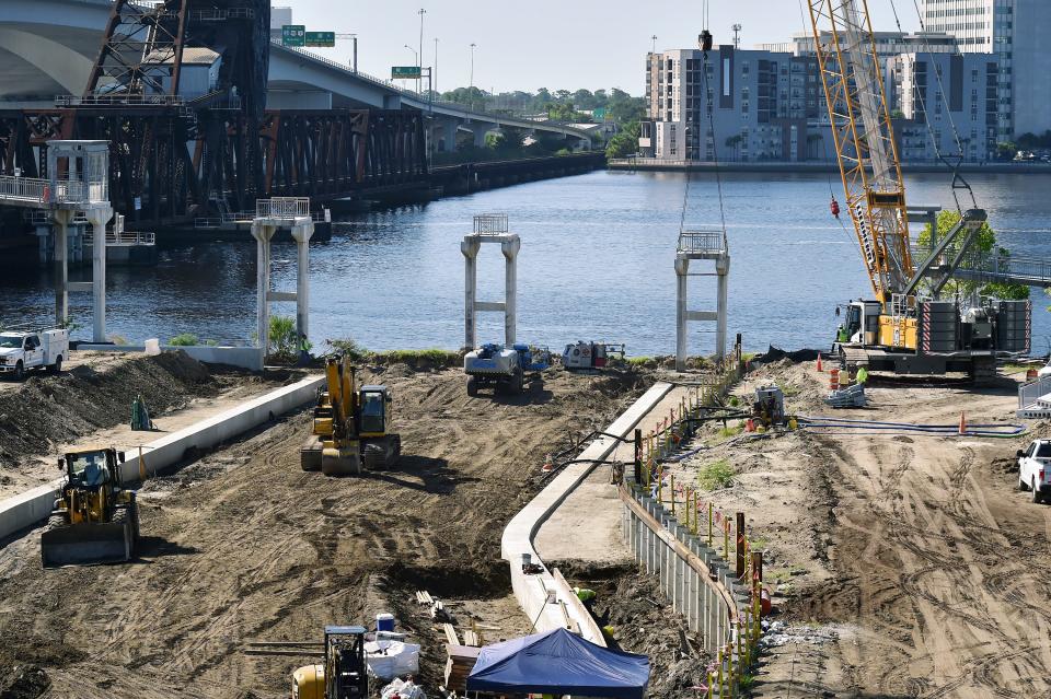 The new channel for McCoys Creek is taking shape as the riverwalk bridge over the outlet point is being demolished on the riverfront property in Jacksonville's Brooklyn neighborhood where McCoys Creek will be rerouted from the man-made tunnel under the former Florida Times-Union property. The reconfigured flow of the creek will be diverted east of the current development to park space adjacent to it where it will feed into the St. Johns River.