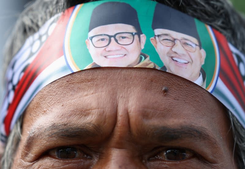 A supporter wears a headband depicting presidential candidate Anies Baswedan and and his running mate Muhaimin Iskandar at Islamic Centre in Ciamis