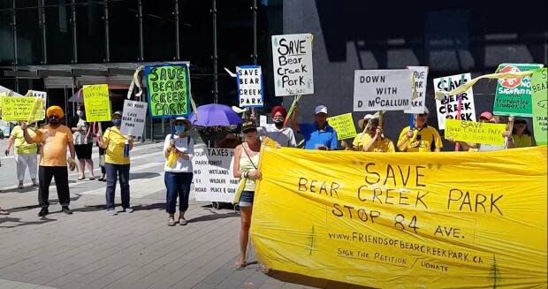 Residents rally outside Surrey City Hall to protest a new road in Bear Creek Park. (Sebastian Sajda - image credit)