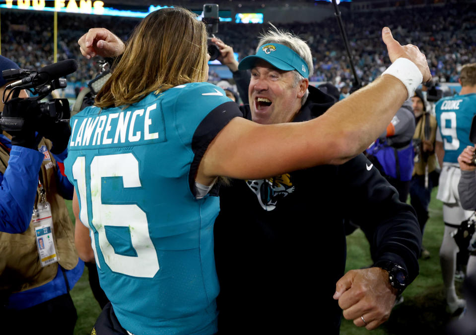 Jan 14, 2023; Jacksonville, Florida, USA; Jacksonville Jaguars head coach Doug Pederson and quarterback <a class="link " href="https://sports.yahoo.com/nfl/players/33389" data-i13n="sec:content-canvas;subsec:anchor_text;elm:context_link" data-ylk="slk:Trevor Lawrence;sec:content-canvas;subsec:anchor_text;elm:context_link;itc:0">Trevor Lawrence</a> (16) celebrate after defeating the Los Angeles Chargers 31-30 during a wild card game at TIAA Bank Field. Mandatory Credit: Mark J. Rebilas-USA TODAY Sports