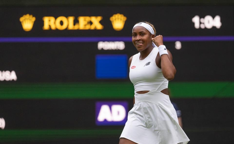 Coco Gauff celebrates winning her opening Wimbledon match against Caroline Dolehide.