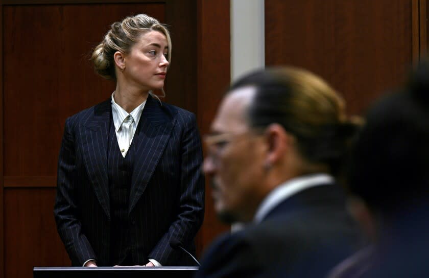 Actors Amber Heard and Johnny Depp, watch the jury arrive in the courtroom at the Fairfax County Circuit Courthouse in Fairfax, Va., Tuesday, May 17, 2022. Depp sued his ex-wife Amber Heard for libel in Fairfax County Circuit Court after she wrote an op-ed piece in The Washington Post in 2018 referring to herself as a "public figure representing domestic abuse." (Brendan Smialowski/Pool photo via AP)