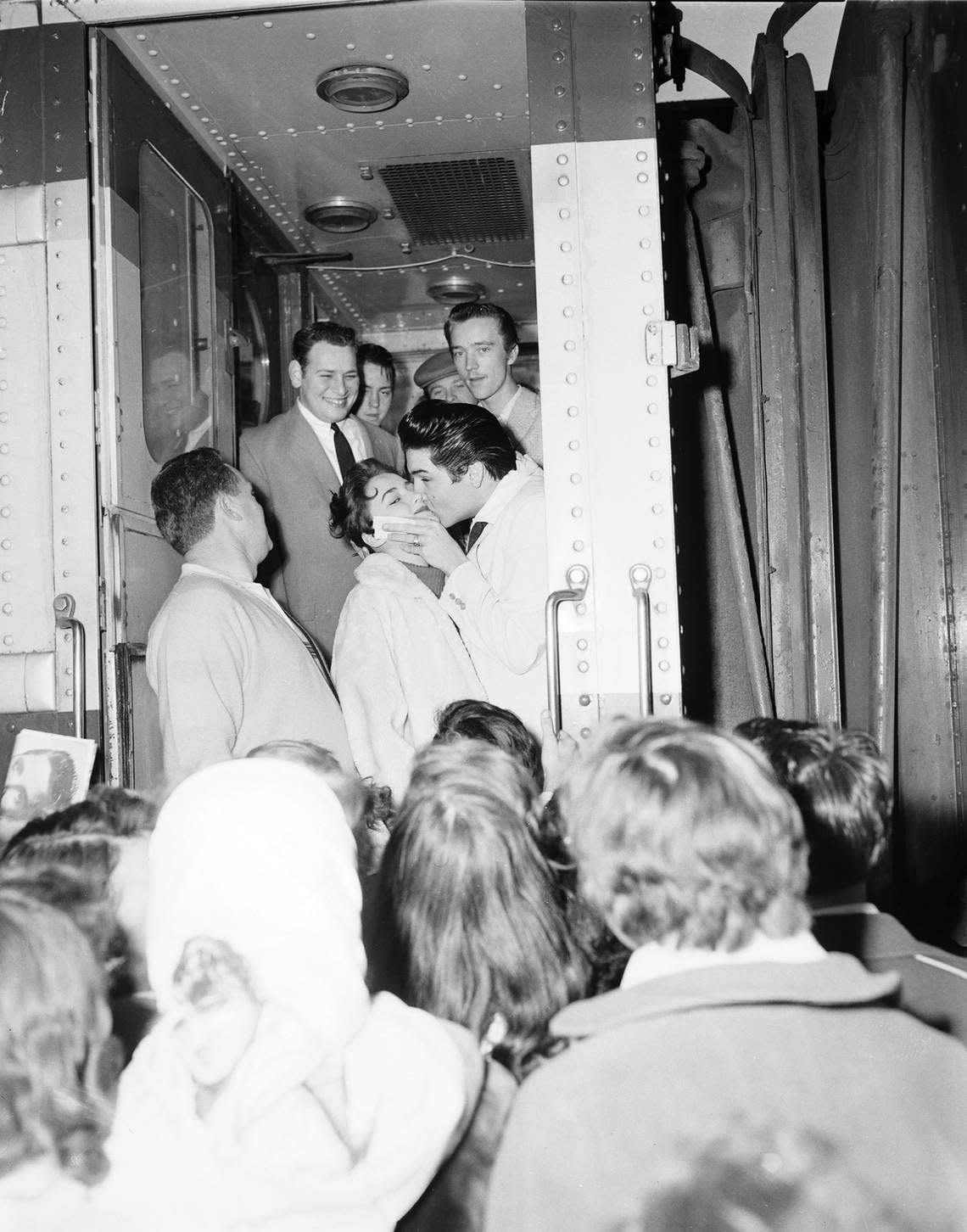 Jan. 11, 1958: Elvis Presley kisses 14-year-old Mary Savage during a stopover on the train in Fort Worth. Ken Moore, a Fort Worth associate of Presley, is at foot of steps.