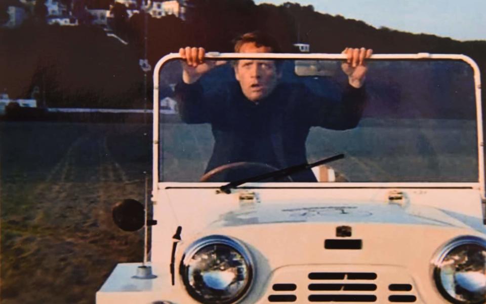 Patrick McGoohan, who starred as 'Number Six' in The Prisoner, with the 1965 Austin Mini Moke used in the cult TV series and which now has been restored - COPYRIGHT JAY WILLIAMS