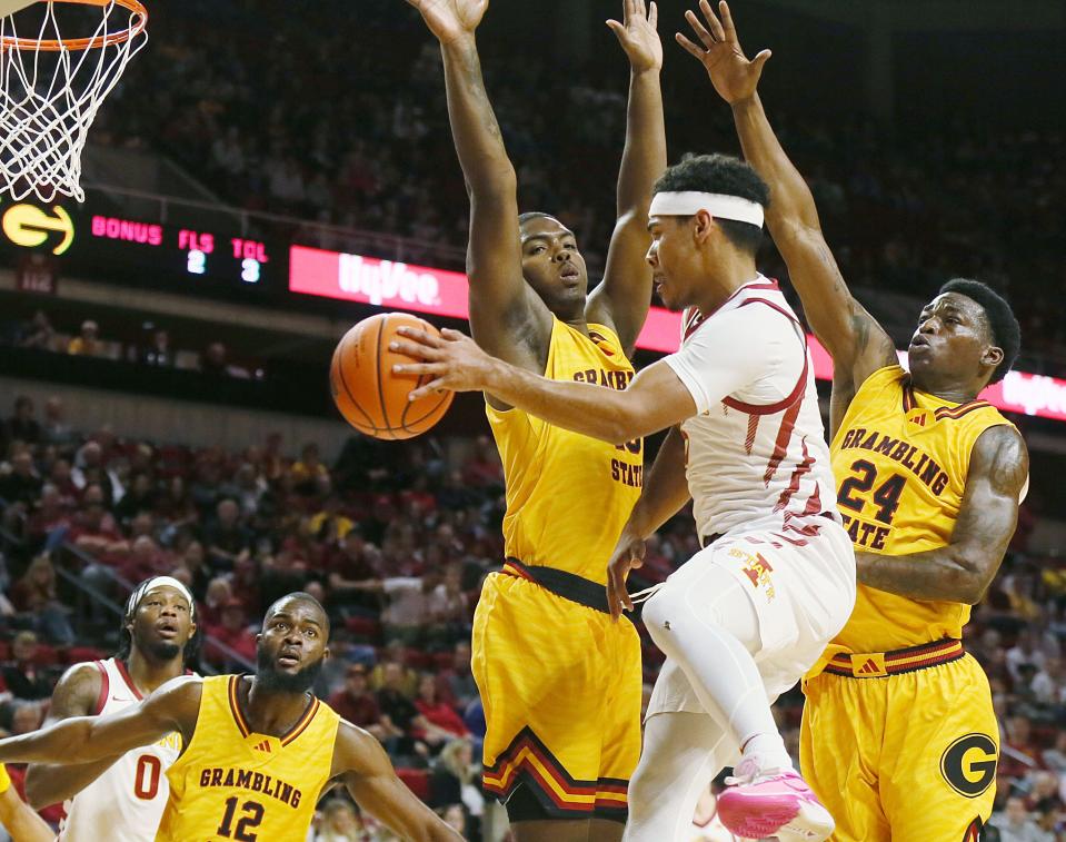 Iowa State Cyclones guard Tamin Lipsey (3) passes the ball as Grambling State forward Jalen Johnson (10) and guard Terrence Lewis (24) defend during the first half in the NCAA men's basketball at Hilton Coliseum on Sunday, Nov. 19, 2023, in Ames, Iowa.