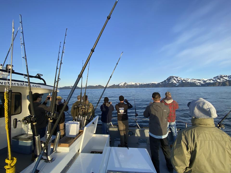 Participants, members of the armed services, and crews of the annual ASYMCA Alaska Combat Fishing Tournament are seen on May 25, 2022, in Seward, Alaska. The tournament, which began in 2007 and now involves more than 300 soldiers, includes a day of deep-water fishing followed by a celebratory banquet with prizes for the largest catch, smallest catch and soldier who got the sickest. (Armed Services YMCA via AP)