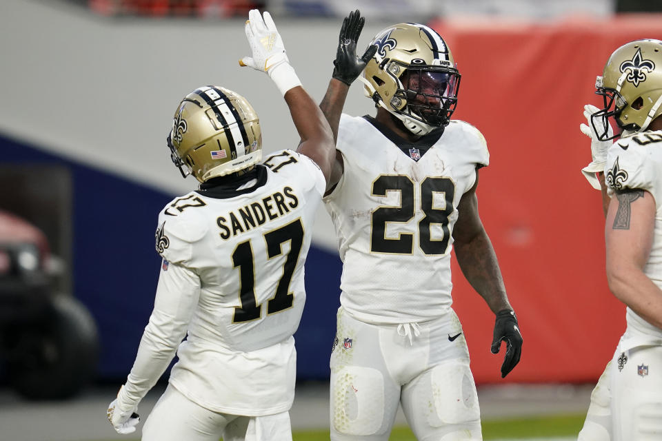 New Orleans Saints running back Latavius Murray (28) celebrates his touchdown run with wide receiver Emmanuel Sanders (17) during the second half of an NFL football game against the Denver Broncos, Sunday, Nov. 29, 2020, in Denver. (AP Photo/David Zalubowski)