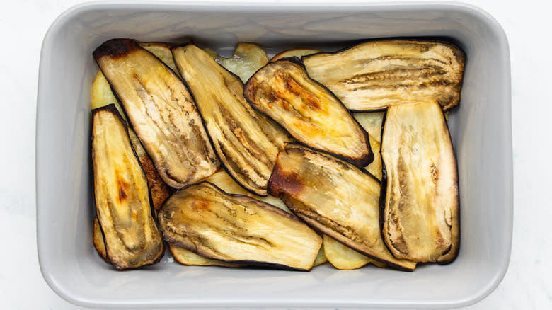 Eggplant and potato slices in baking dish