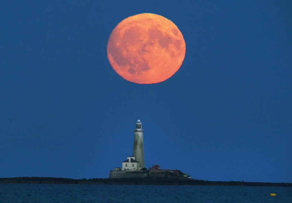 The Full Buck supermoon rises over St Mary's Lighthouse in Whitley Bay, on the North East coast of England. The July supermoon is arriving to its closest point to Earth at 224,895 miles (361,934km) - around 13,959 miles (22,466km) closer than usual. It appears 5.8 per cent bigger and 12.8 per cent brighter than an ordinary full moon. Picture date: Sunday July 2, 2023. (Photo by Owen Humphreys/PA Images via Getty Images)