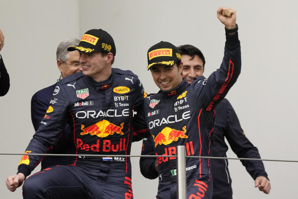 Red Bull driver Max Verstappen, left, of the Netherlands, winner of the Emilia Romagna Formula One Grand Prix, celebrates on the podium with second placed Red Bull driver Sergio Perez, of Mexico, at the Enzo and Dino Ferrari racetrack, in Imola, Italy, Sunday, April 24, 2022. (AP Photo/Luca Bruno)