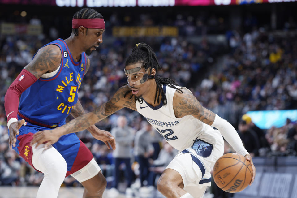 Memphis Grizzlies guard Ja Morant drives as Denver Nuggets guard Kentavious Caldwell-Pope defends during the second half of an NBA basketball game Friday, March 3, 2023, in Denver. (AP Photo/David Zalubowski)