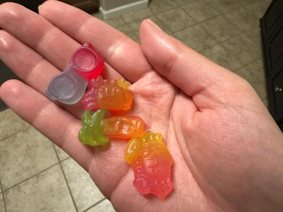multicolored gummy shapes in someone's hand