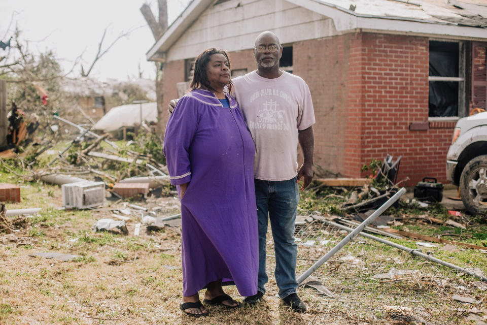 James Anderson and his sister Barbie stand in front of their home where they stayed during the tornado that ripped through Rolling Fork, Miss., two days earlier, on March 26, 2023. (Imani Khayyam for NBC News)