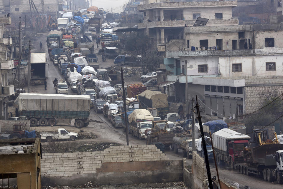 Syrian flee the advance of the government forces in the province of Idlib, Syria, towards the Turkish border, Thursday, Jan. 30, 2020. Warplanes struck a town in a rebel-held enclave in northwestern Syria, killing several people, including some who were fleeing the attack, opposition activists and a rescue service said Thursday. The attack, believed to have been carried out by Russian warplanes backing a Syrian government offensive, also put a local hospital out of service, they said. (AP Photo/Ghaith Alsayed)