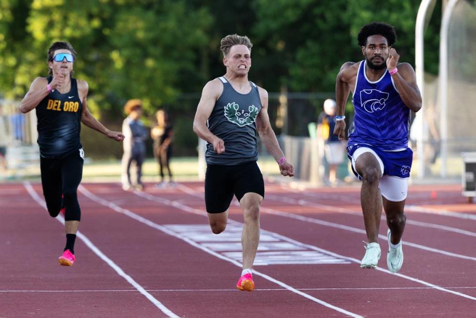 Pitman’s Joey Stout, middle, challenges Ian Dossman of Franklin-EG, right, in the 200 meter race during the CIF Sac-Joaquin Section Masters track finals at Davis High School in Davis, Calif., Saturday, May 20, 2023. Stout finished second with a time of 21.84. Andy Alfaro/aalfaro@modbee.com