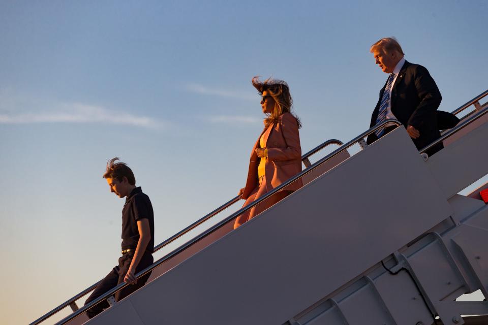 In this 2018 photo, Barron Trump precedes Melania and President Donald Trump as they depart Air Force One at Palm Beach International Airport.