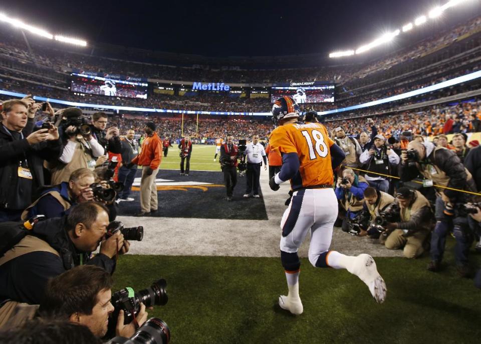 Denver Broncos quarterback Peyton Manning runs onto the field before the NFL Super Bowl XLVIII football game against the Seattle Seahawks Sunday, Feb. 2, 2014, in East Rutherford, N.J. (AP Photo/Evan Vucci)