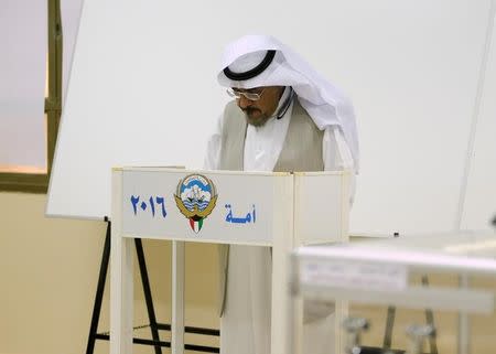 A Kuwaiti man casts his vote during parliamentary election in a polling station in Kuwait City, Kuwait November 26, 2016. REUTERS/Stringer