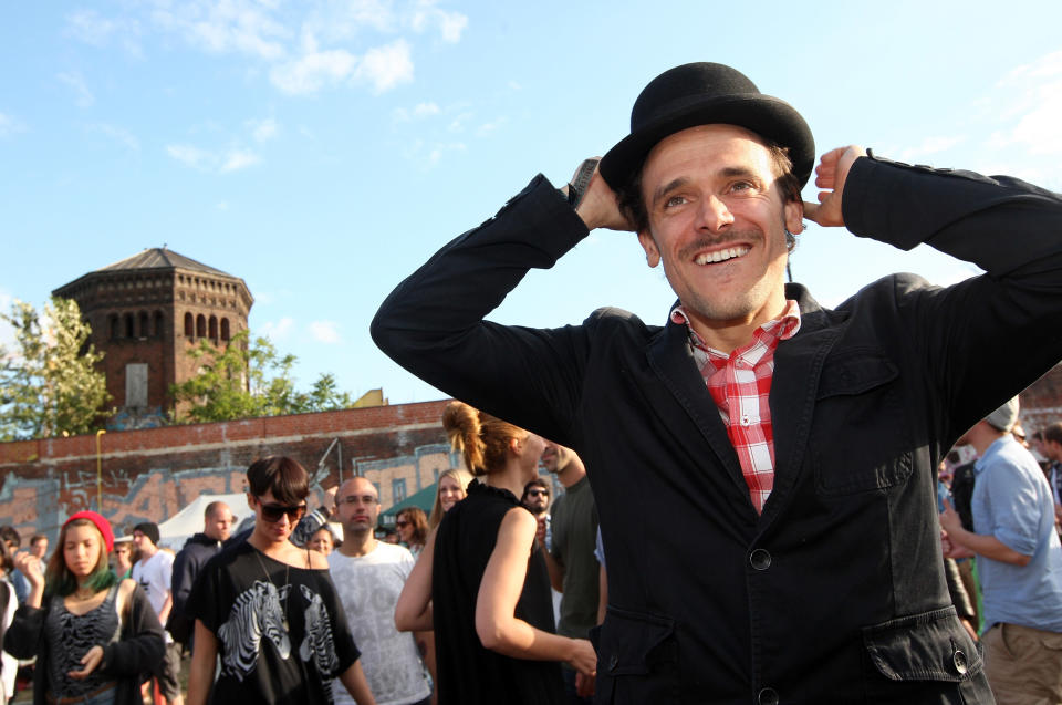 BERLIN, GERMANY - JULY 21: An attendee dances during the second annual Hipster Olympics on July 21, 2012 in Berlin, Germany. With events such as the "Horn-Rimmed Glasses Throw," "Skinny Jeans Tug-O-War," "Vinyl Record Spinning Contest" and "Cloth Tote Sack Race," the Hipster Olympics both mocks and celebrates the Hipster subculture, which some critics claim could never be accurately defined and others that it never existed in the first place. The imprecise nature of determining what makes one a member means that the symptomatic elements of adherants to the group vary in each country, but the archetype of the version in Berlin, one of the more popular locations for those following its lifestyle, along with London and Brooklyn, includes a penchant for canvas tote bags, the carbonated yerba mate drink Club Mate, analogue film cameras, asymmetrical haircuts, 80s neon fashion, and, allegedly, a heavy dose of irony. To some in Berlin, members of the hipster "movement" have replaced a former unwanted identity in gentrifying neighborhoods, the Yuppie, for targets of criticism, as landlords raise rents in the areas to which they relocate, particularly the up-and-coming neighborhood of Neukoelln. (Photo by Adam Berry/Getty Images)