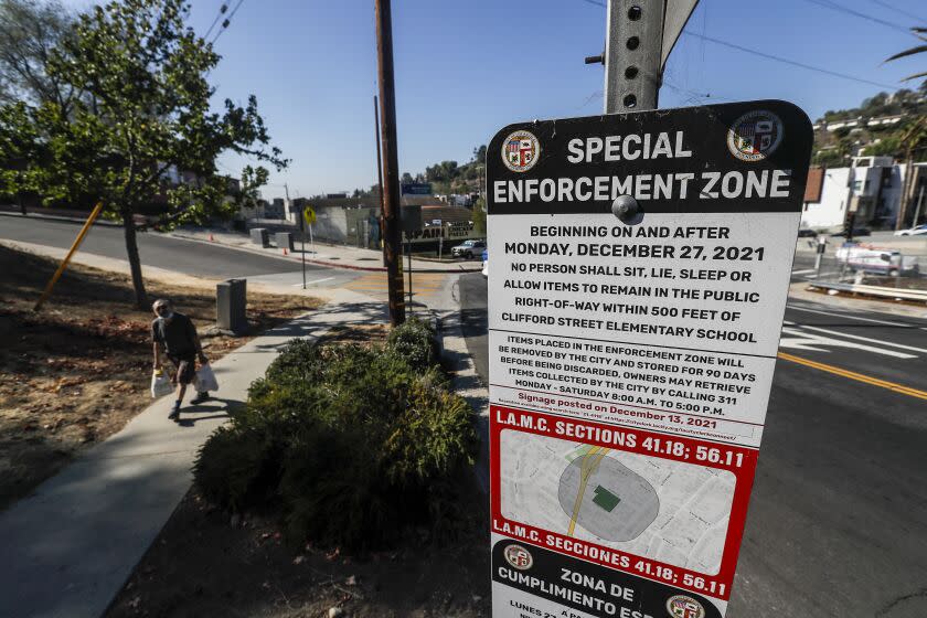 Los Angeles, CA, Tuesday, October 4, 2022 - Echo Park resident Stan Gale lives near one of L.A.'s new anti-encampment zones. He says that his neighborhood was a "war zone" when it had an encampment nearby, with screaming, thefts and gunfire. The zone was created by Councilman Mitch O'Farrell, who is in a tough re-election fight, and now the encampment is gone. Signs posted on Allesandro St. warning of new anti-camping laws. (Robert Gauthier/Los Angeles Times)