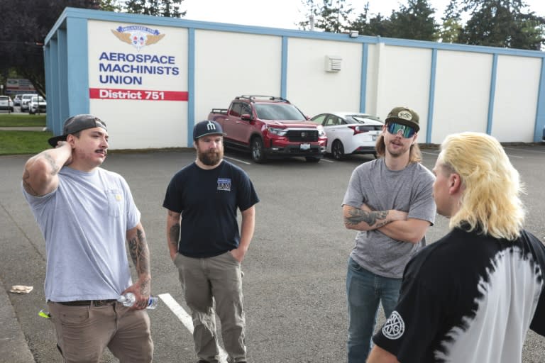 Boeing mechanics (from L) Nick Hudson, Joe Philbin, Blake Thayer and Ajay Fraatz gather outside after submitting their votes on whether to strike (Jason Redmond)