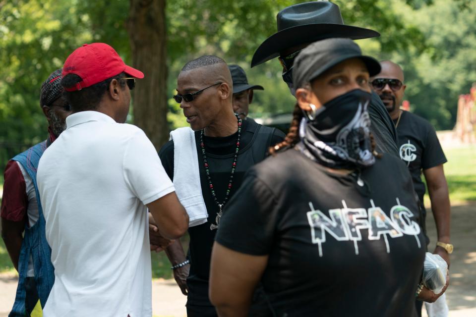 Grandmaster Jay greets supporters as members of his security team stand guard during a "Feed the People" event July 24, 2021, in Louisville.