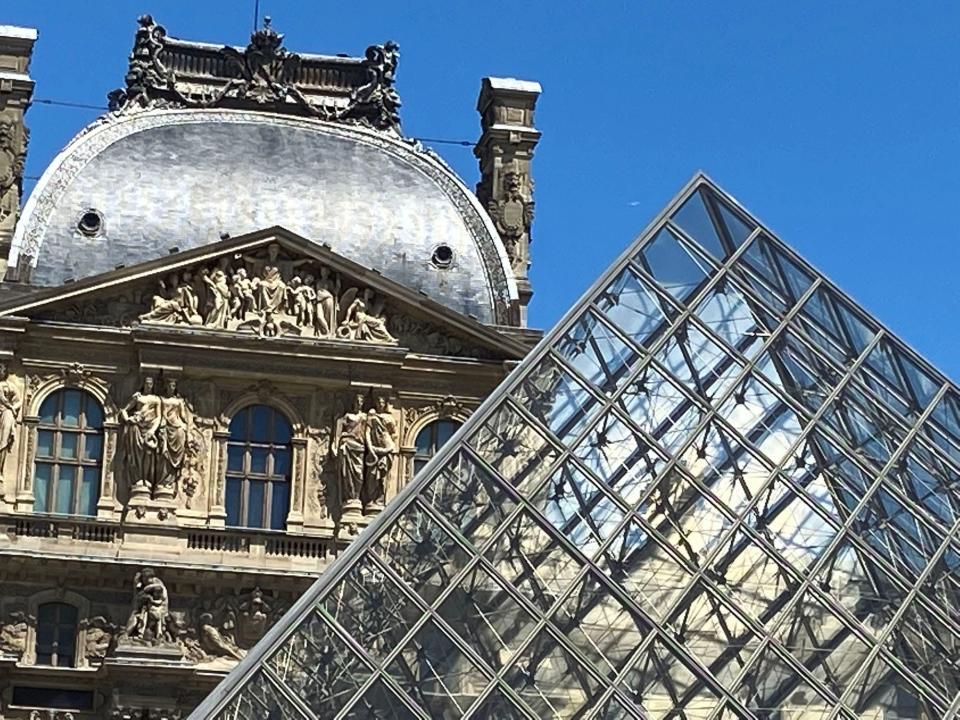 The Louvre Museum and glass pyramids in Paris.