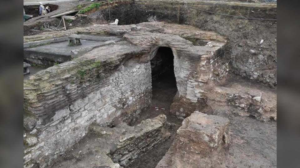 The chambers are being prepared to allow visitors to explore the underground archaeology of the church ruins. Here we see a stone structure with a rectangular doorway leading down to the underground chambers.