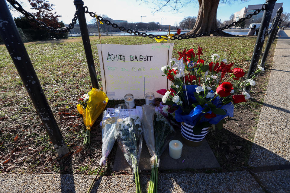 WASHINGTON D.C., USA - JANUARY 07: People place flowers and candles for Ashli Babbit, an Air Force veteran who was shot and killed in the U.S Capitol building yesterday was honored by The U.S Capitol building in Washington D.C., United States on January 07, 2020. (Photo by Tayfun Coskun/Anadolu Agency via Getty Images)