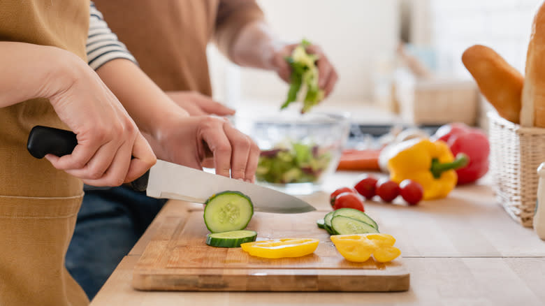 Hands cutting vegetables 