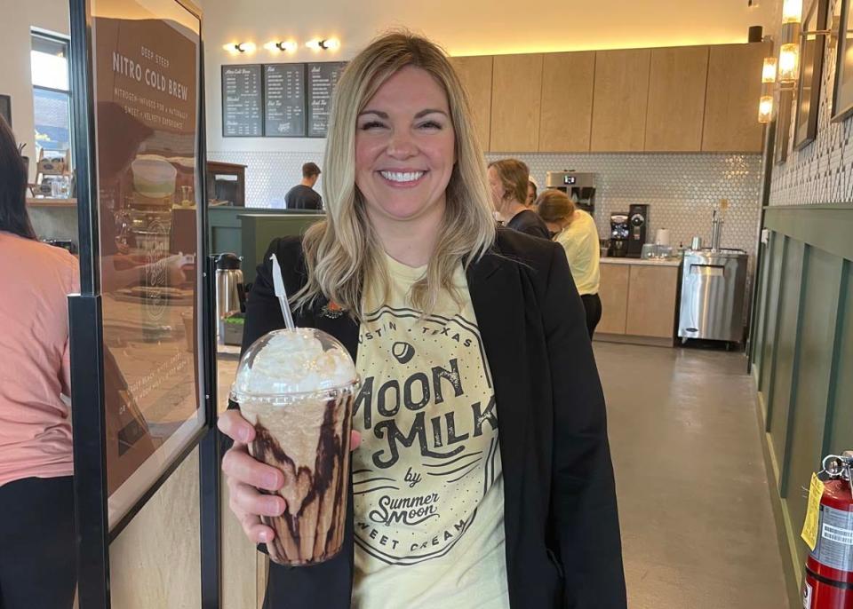 Owner Heidi Davis offers up a delicious espresso chocolate shake at the grand opening of Summer Moon, a specialty coffee shop in Farragut, Saturday, April 30, 2022.