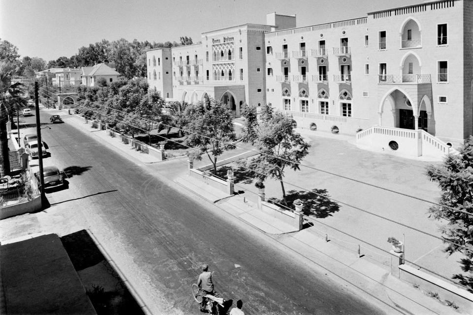 This 1959 photo provided from the Cyprus' press and informations office shows the Ledra Palace Hotel in capital Nicosia, Cyprus. This grand hotel still manages to hold onto a flicker of its old majesty despite the mortal shell craters and bullet holes scarring its sandstone facade. Amid war in the summer of 1974 that cleaved Cyprus along ethnic lines, United Nations peacekeepers took over the Ledra Palace Hotel and instantly turned it into an emblem of the east Mediterranean island nation's division. (Press and informations Office via AP)