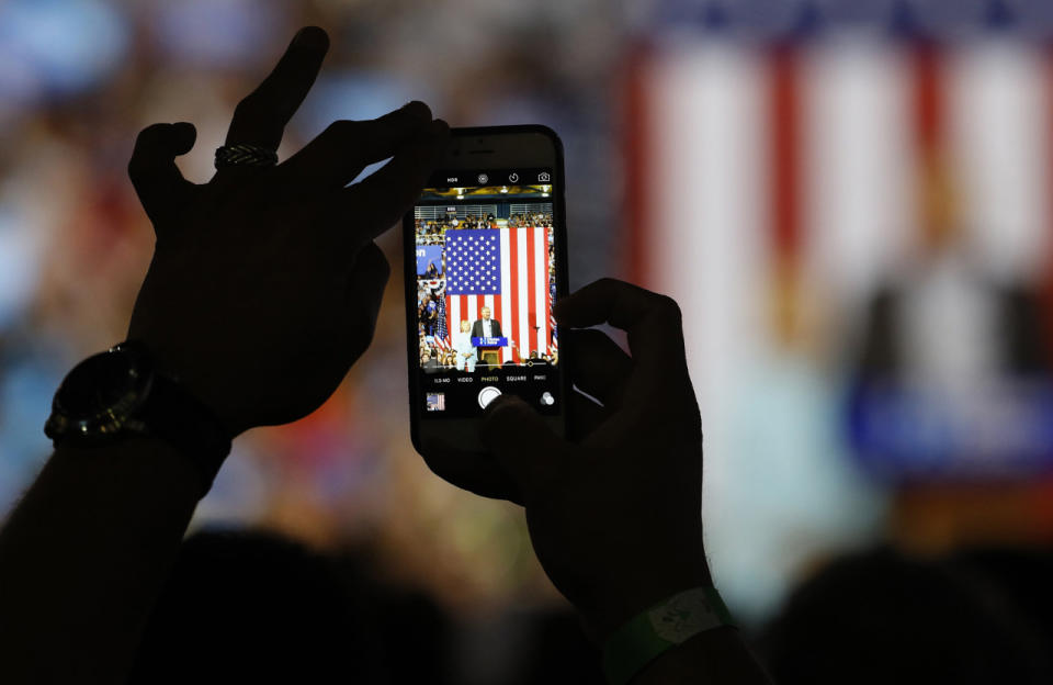 An attendee shoots a photo of Democratic U.S vice presidential candidate Kaine speaking