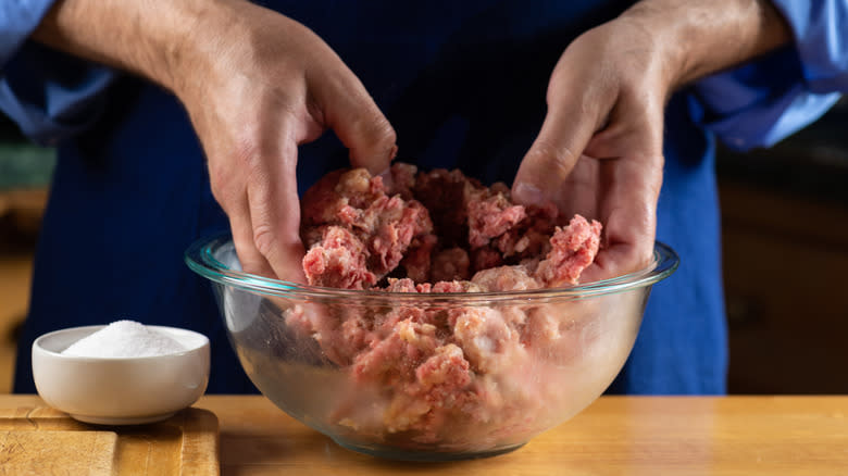 hand mixing meatloaf in bowl