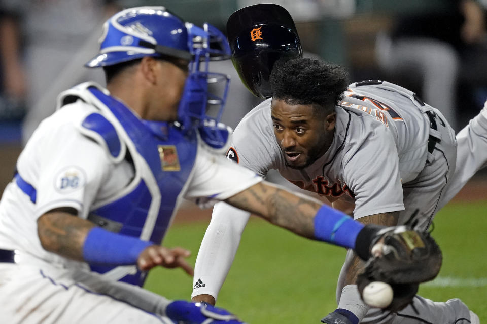 Detroit Tigers' Niko Goodrum beats the throw to Kansas City Royals catcher Salvador Perez to score on a sacrifice fly by Eric Haase during the seventh inning of a baseball game Friday, Sept. 25, 2020, in Kansas City, Mo. (AP Photo/Charlie Riedel)