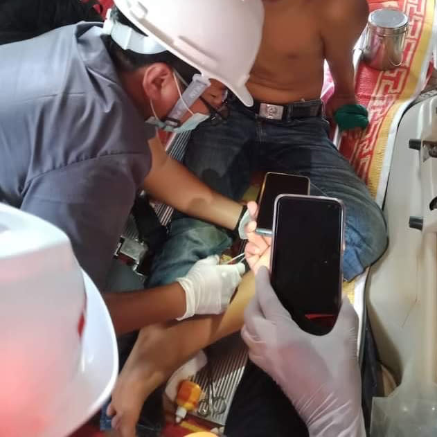 In this March 16, 2021 photo obtained by The Associated Press, Dr. Nay Lin Tun tends to a man wounded in the back and legs by rubber bullets during a protest in Yangon, Myanmar. “In other country’s protests, the medics are safe. They are exempt. Here, there are no exemptions,” says the general practitioner who has been on the run since February, and now provides care covertly. (AP Photo)