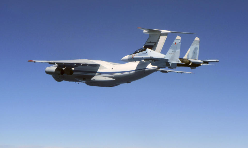 CAPTION CORRECTS AIRCRAFT NAME - In this photo taken on Saturday June 15, 2019, a Russian Su-30 Flanker fighter escorts an Ilyushin Il-76 Candid transport aircraft, left, as they fly over the Baltic Sea. Two Royal Air Force jets deployed in Estonia have been scrambled twice in recent days, bringing the number of intercepts of Russian aircraft to eight since taking over the Baltic Air Policing mission in early May. The Typhoon jets were alerted Friday to intercept a Russian Su-30 Flanker fighter, and passed a military transport craft as it was escorting the fighter over the Baltic Sea. In a second incident on Saturday, RAF crews intercepted a Su-30 Flanker fighter and an Ilyushin Il-76 Candid transport aircraft that was traveling north from the Russian enclave of Kaliningrad toward Estonian and Finnish airspace. (UK Ministry of Defence via AP)