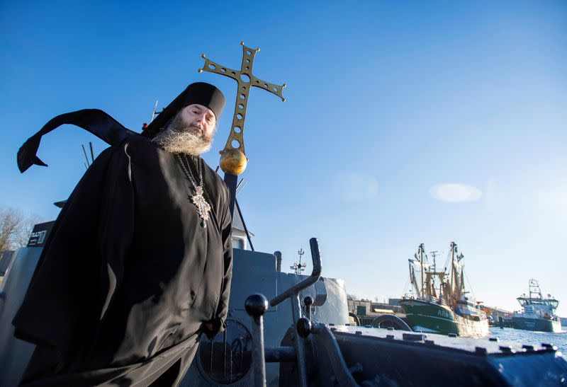 Father Abbot Abibos poses on the front deck of a mobile Georgian Orthodox monastery in Vlissingen