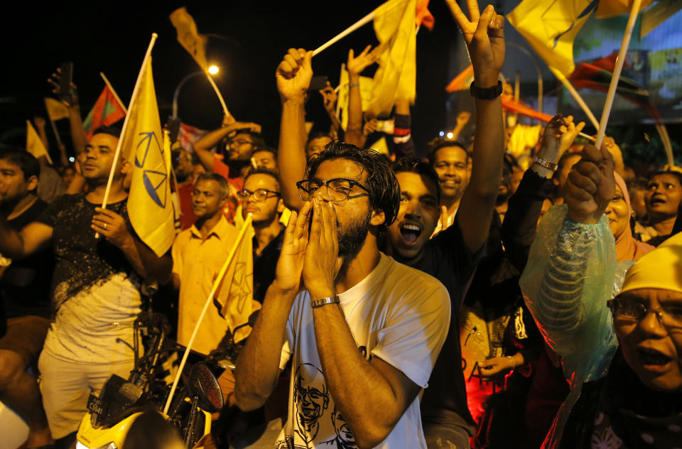 Supporters of Maldives' opposition presidential candidate Ibrahim Mohamed Solih celebrate their victory in Male, Maldives, Monday, Sept. 24, 2018. A longtime but little-known lawmaker Solih declared victory at his party's campaign headquarters in the capital city Male in a contentious election widely seen as a referendum on the island nation's young democracy.(AP Photo/Eranga Jayawardena)