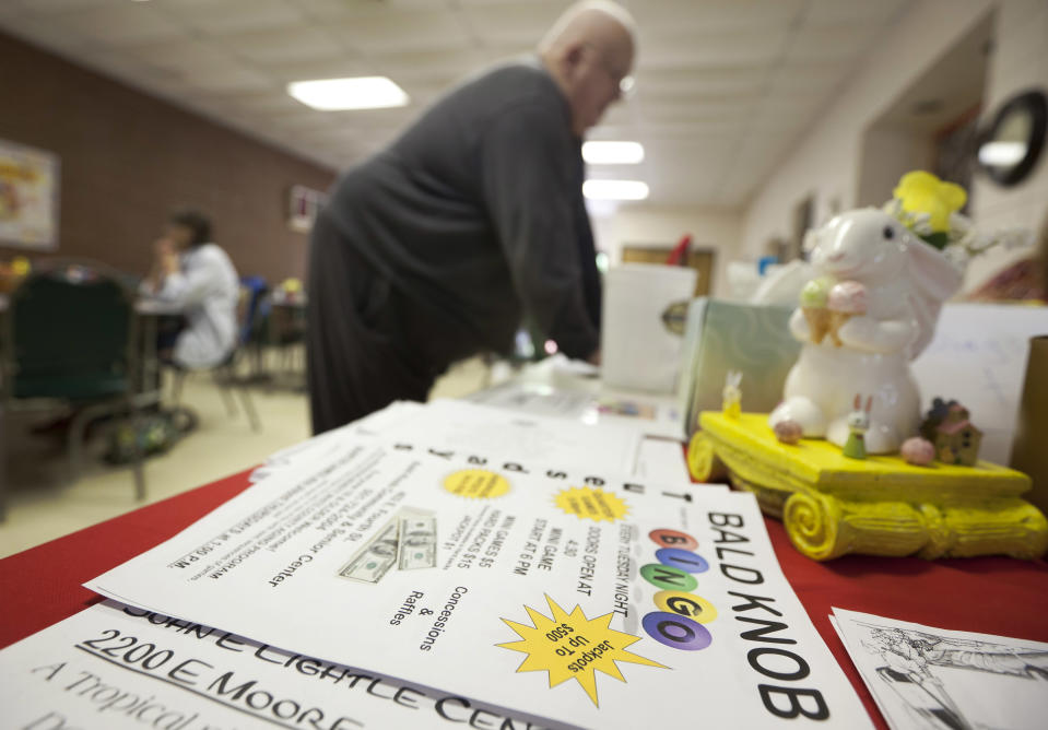In this photo taken Tuesday, April 10, 2012, John Lancaster from Floyd, Ark., buys Bingo cards before a game in Bald Knob, Ark. (AP Photo/Danny Johnston)