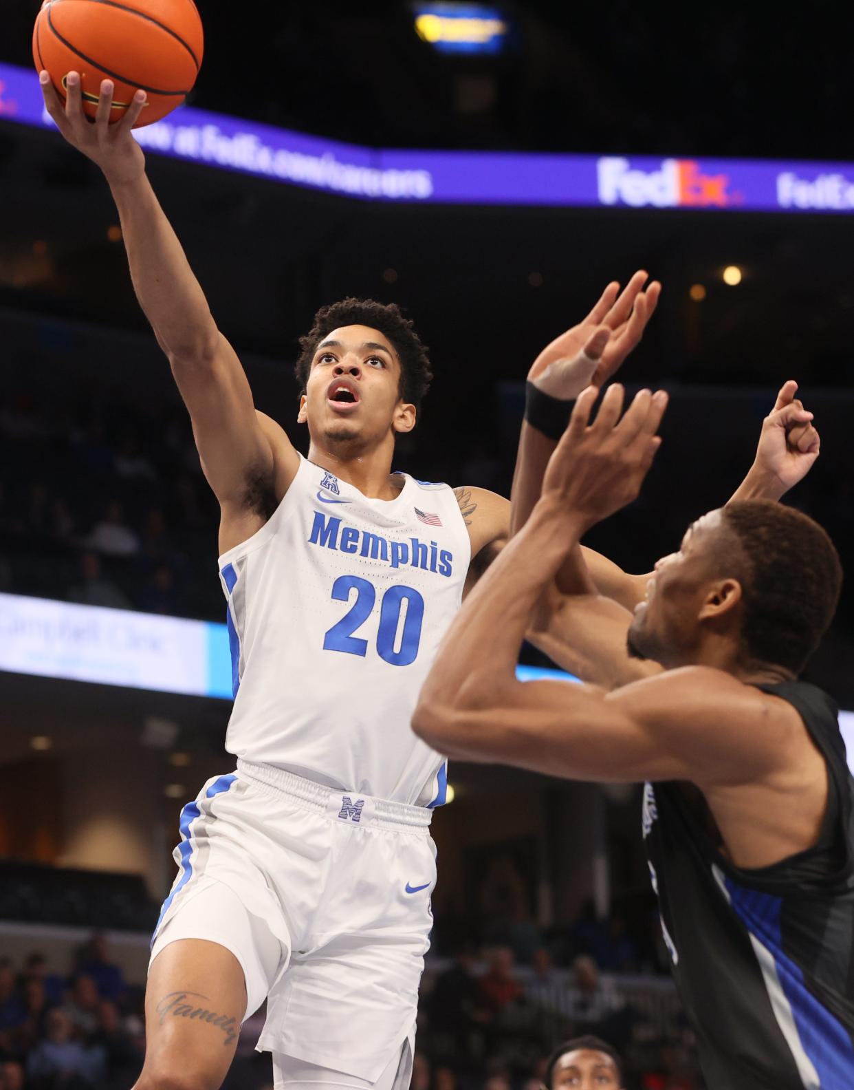 Memphis Tigers forward Josh Minott lays the ball up past Saint Louis Billikens forward Francis Okoro during their game at FedExForum on Tuesday, Nov. 16, 2021. 