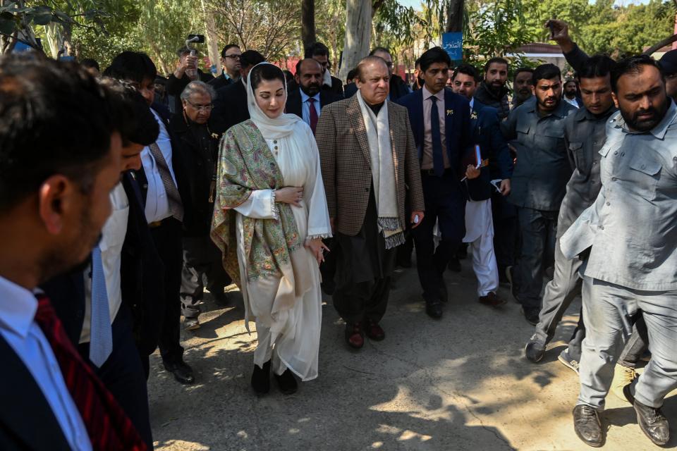 PML-N candidate Nawaz Sharif (C) along with his daughter Maryam Nawaz (C, left) leaves after casting his ballot to vote in Lahore (AFP via Getty Images)